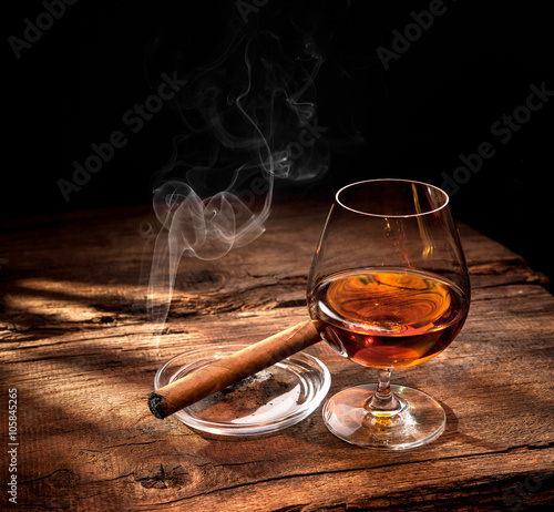Whiskey with smoking cigar