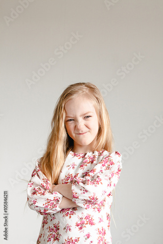 emotional portrait of little girl with long blond hair wearing a blouse with floral print эмоциональный портрет маленькой девочки с длинными светлыми волосами в блузке с цветочным принтом