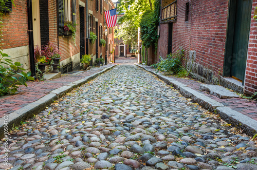 Narrow Stone Street lined with Brick Terraced Houses