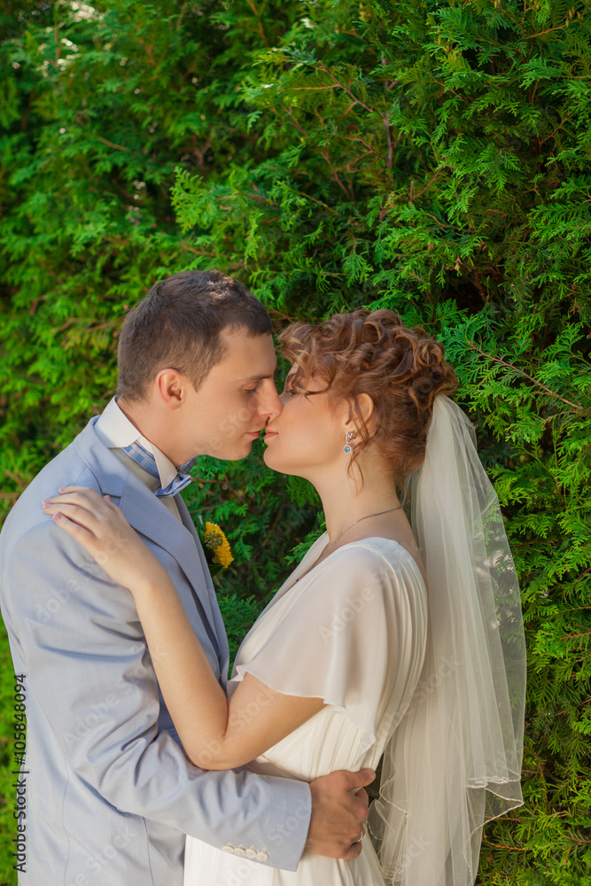 The groom kisses the bride tenderly The groom kisses the bride tenderly