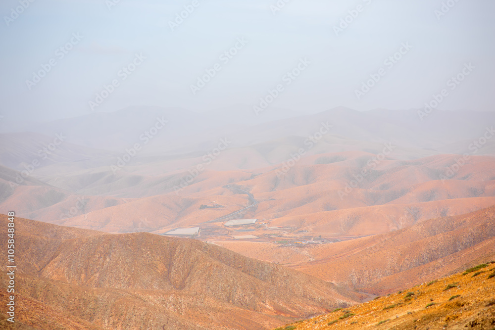 Mountain landscape at the central part of Fuerteventura island on the cloudy and foggy weather in Spain