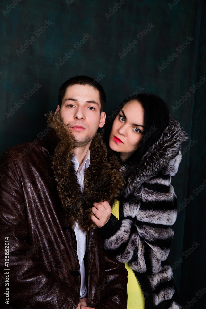 Young attractive couple. Handsome man and sexy woman in fur coat