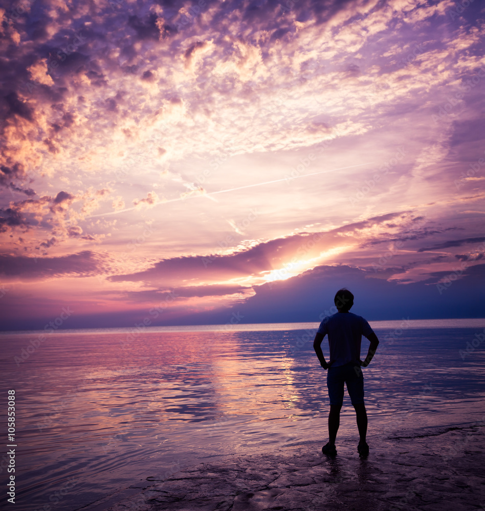 Silhouette of Man Enjoying Sunset at Sea