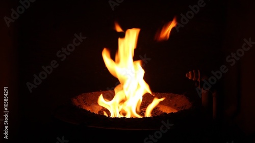 The fire in the furnace. Heating system. Solid fuel boiler. Open fire.