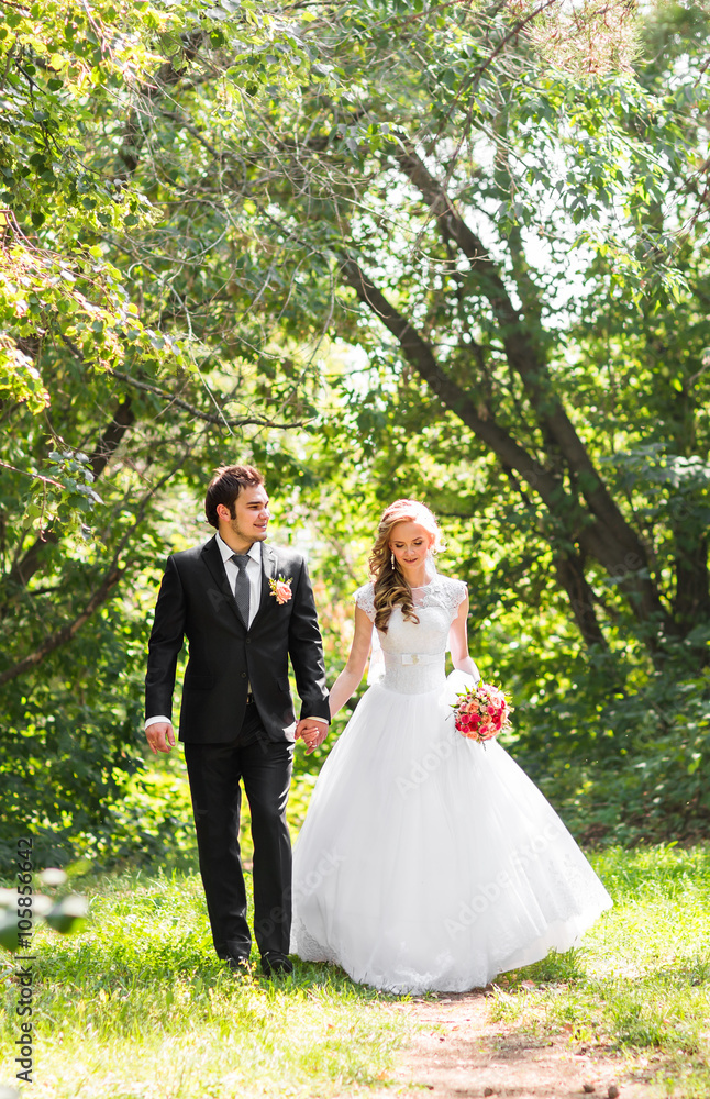 Romantic wedding couple having fun together outdoor in nature Romantic wedding couple having fun together outdoor in nature