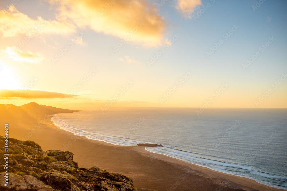 Top view on Cofete beach and mountains on Jandia peninsula on Fuerteventura island on the sunset in Spain Top view on Cofete beach and mountains on Jandia peninsula on Fuerteventura island on the sunset in Spain