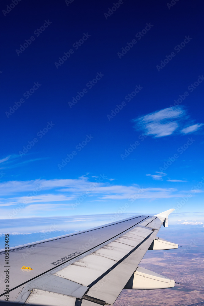 view of the wing of an airplane through the window view of the wing of an airplane through the window