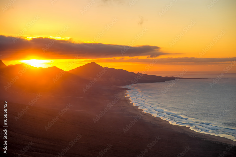 Top view on Cofete beach and mountains on Jandia peninsula on Fuerteventura island on the sunset in Spain