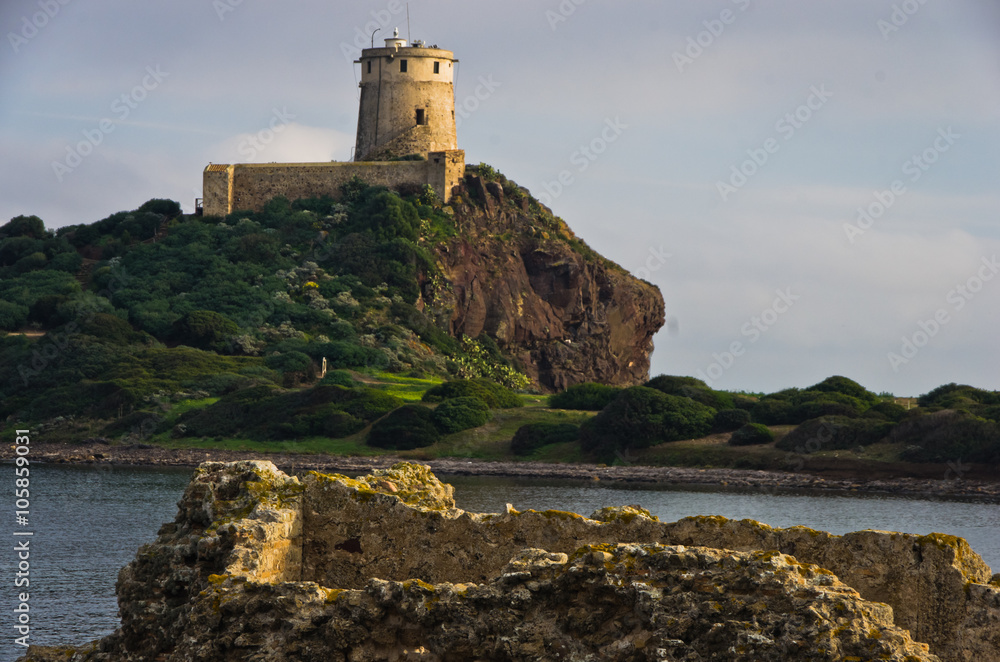 Tower Coltellazzo of Saint Efisio lighthouse at Nora archeological site, gulf of Cagliari, Sardinia, Italy