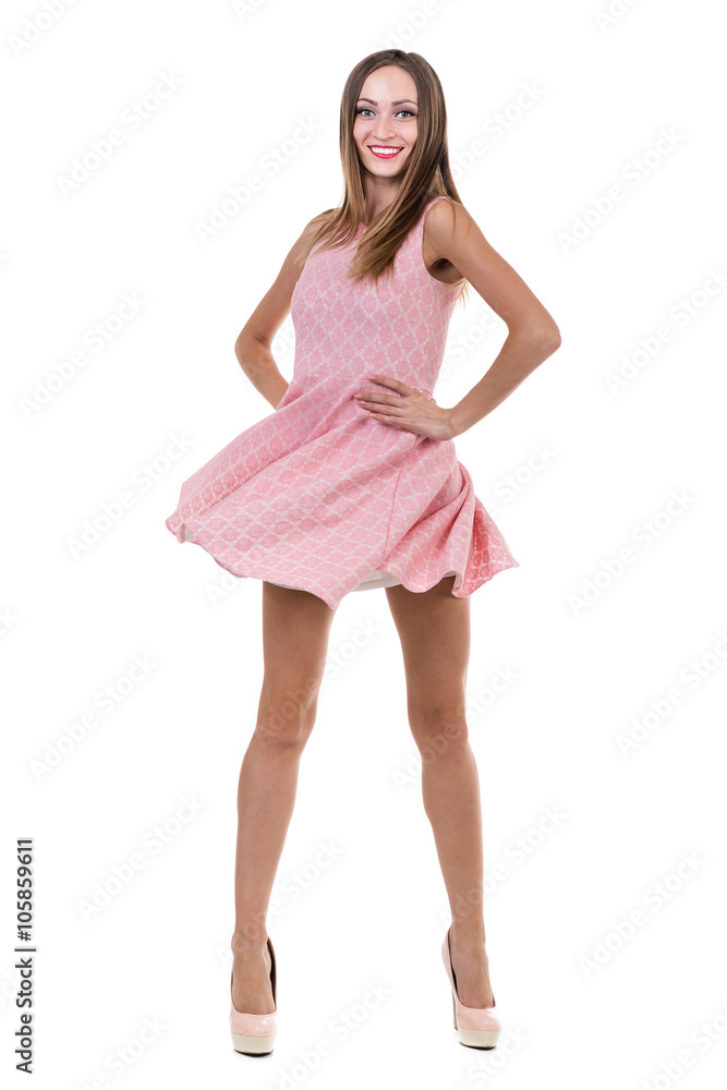 Naklejka premium Full length of sensual woman in short dress dancing against isolated white