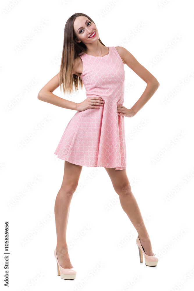 Full length of sensual woman in short dress dancing against isolated white