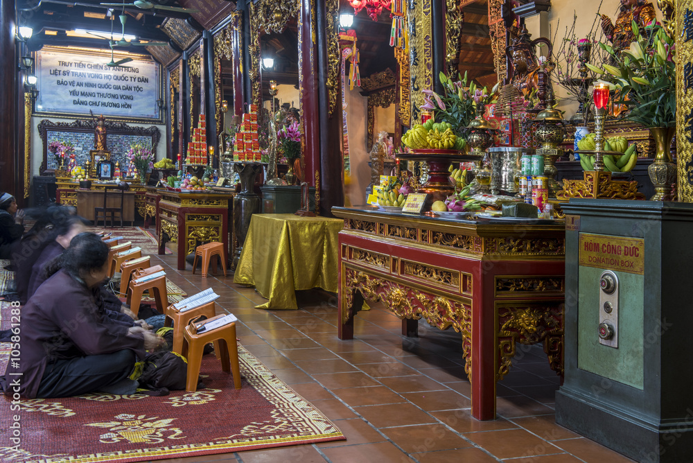 Women praying inside the Tran Quoc Pagoda, Hanoi, Vietnam