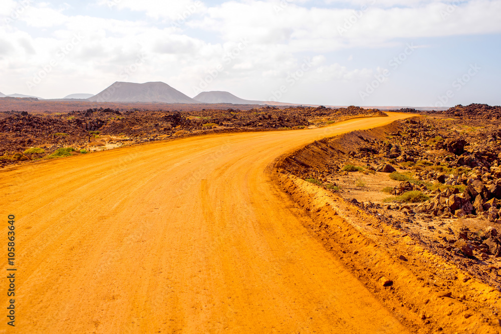 Ground road at Corralejo dunes with mountains on the background on Fuerteventura island in Spain
