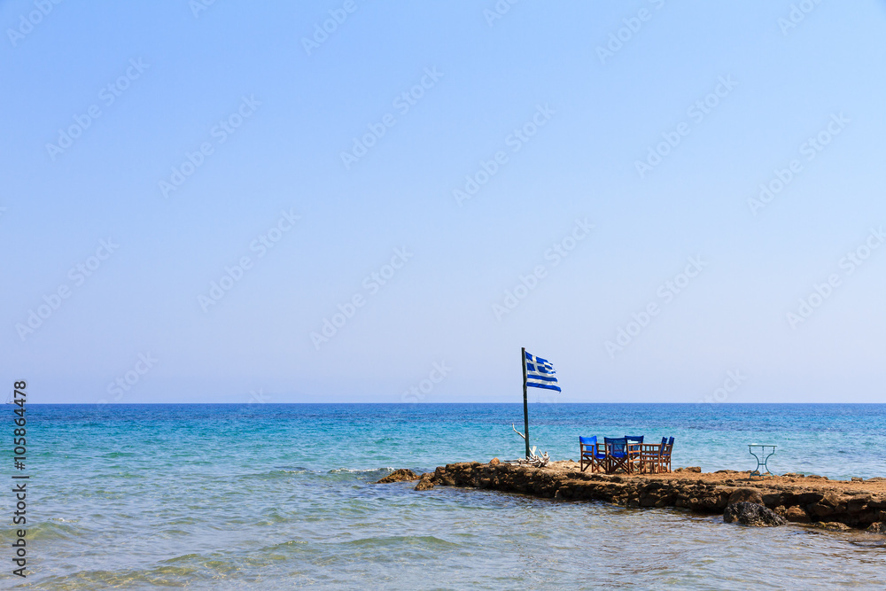 Greek flag at the end of a jetty on the island Zakynthos in summer