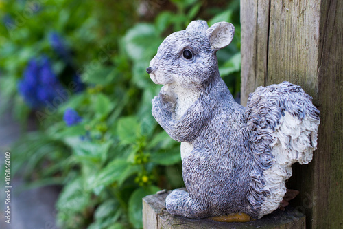 Squirrel garden decoration on wooden post