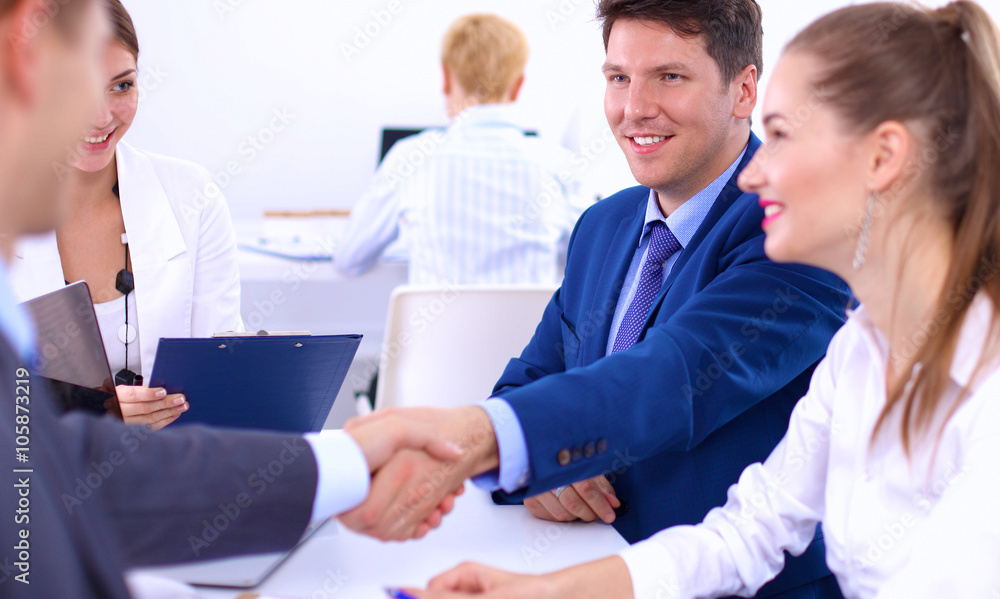 Business people shaking hands, finishing up a meeting, in office Business people shaking hands, finishing up a meeting, in office
