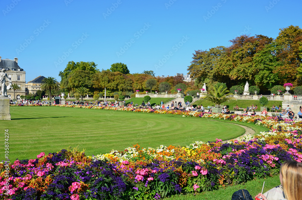 People enjoy sunny day in the Luxembourg Garden in Paris. Luxembourg Palace is the official residence of the French Senate. People enjoy sunny day in the Luxembourg Garden in Paris. Luxembourg Palace is the official residence of the French Senate.