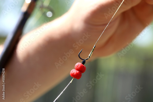 red fishing bait in man hand under the hook © dobok