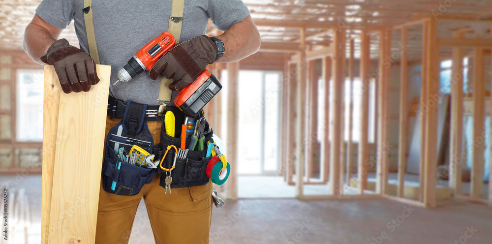 Builder handyman with drill and wooden plank. Builder handyman with drill and wooden plank.