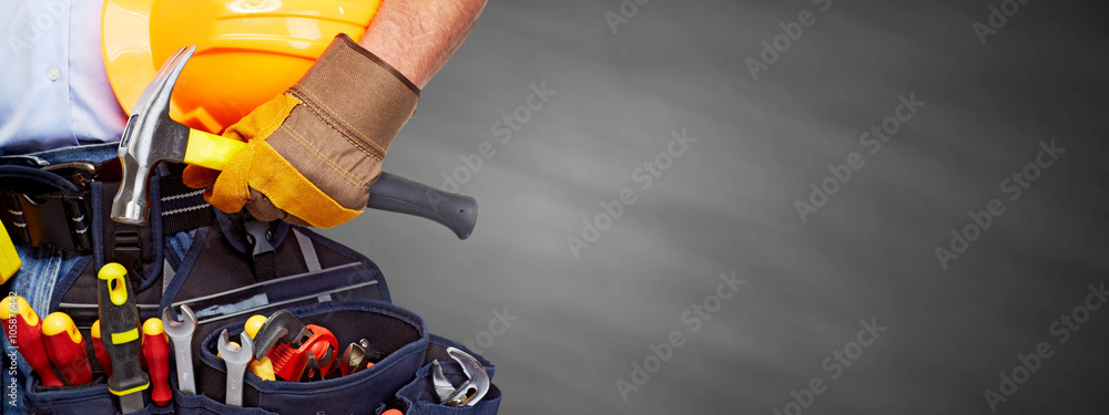 Builder handyman with construction tools. - obrazy, fototapety, plakaty 
