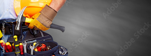 Builder handyman with construction tools. © grinny