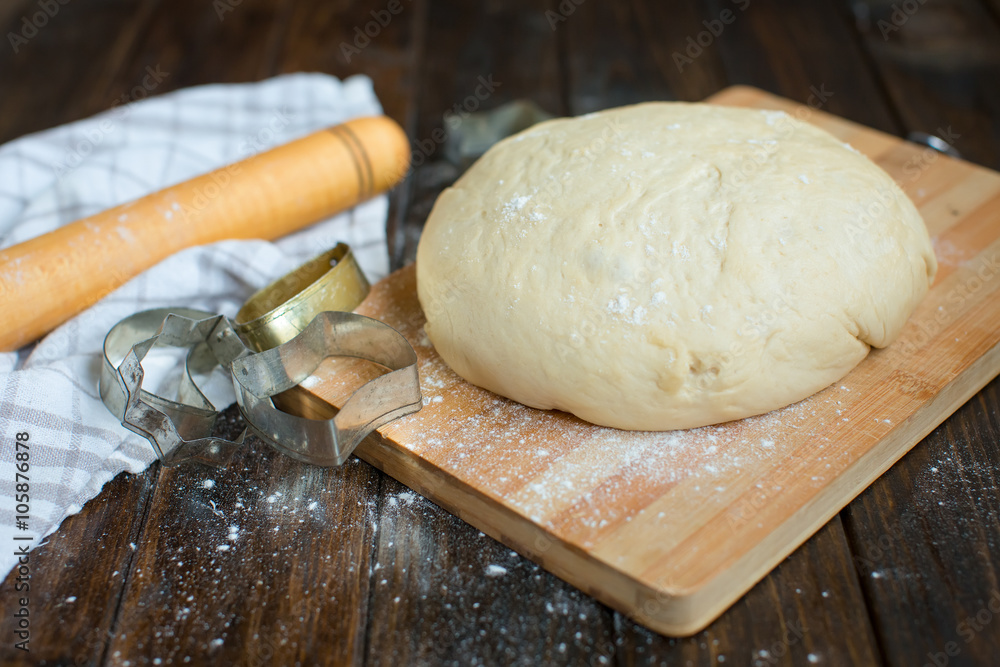 Ball of dough on a rustic wooden background with dusting of flour Ball of dough on a rustic wooden background with dusting of flour
