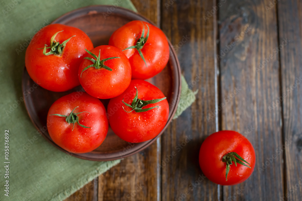 juicy and beautiful tomatoes on wooden rustic background juicy and beautiful tomatoes on wooden rustic background
