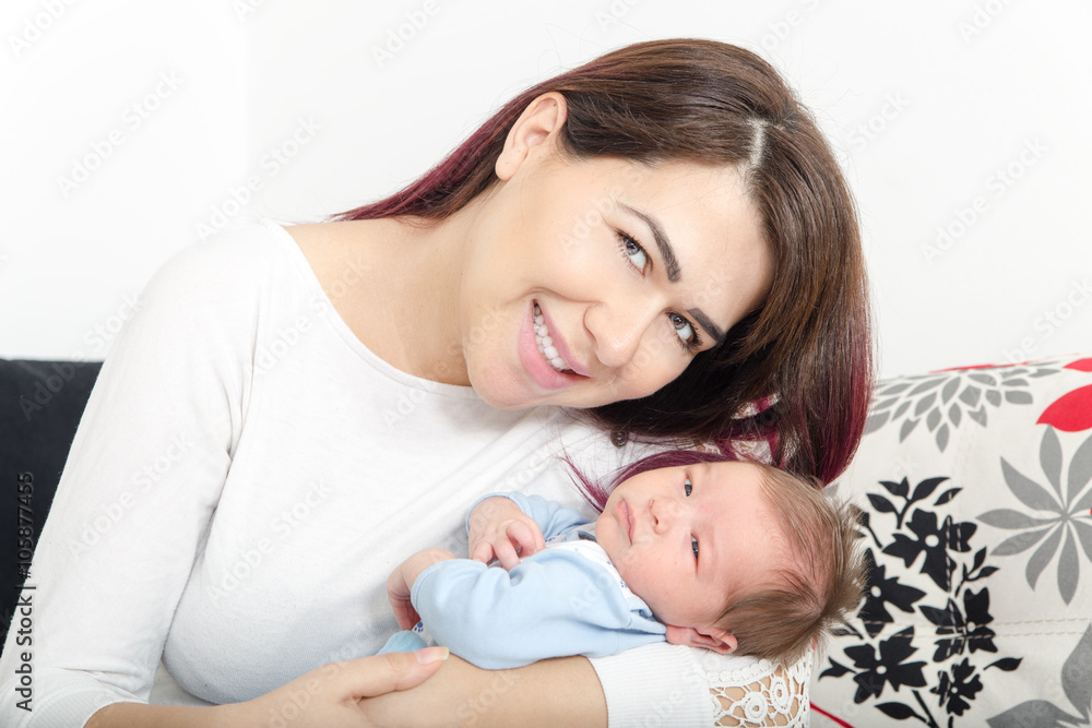 Healthy Woman and New Born Boy Relax in White Bedroom or Living Healthy Woman and New Born Boy Relax in White Bedroom or Living