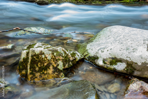 Snow Melt Rushing Past Mossy Boulders