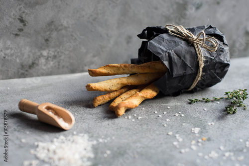 Fresh baked homemade breadsticks grissini with thyme and sea salt. photo