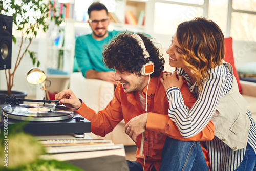 Group of friends listening music - vinyl at home