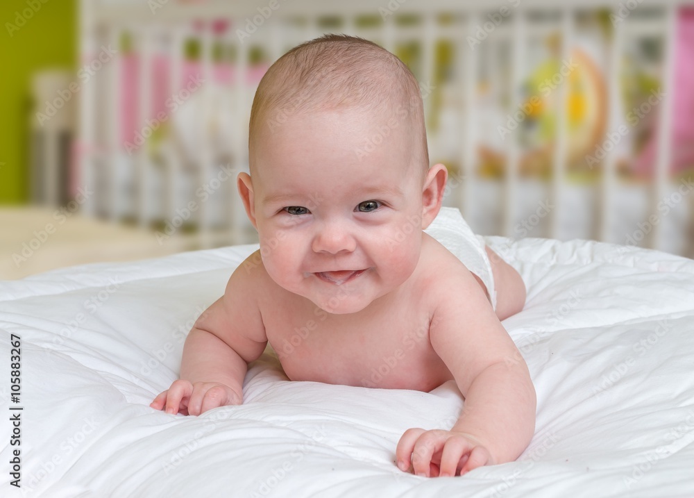 Cute and smiling crawling baby girl lying on belly. Cute and smiling crawling baby girl lying on belly.