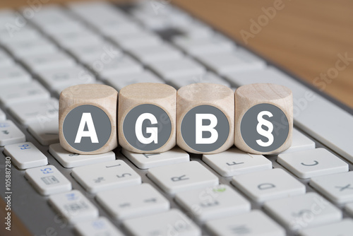 Würfel mit Abkürzung AGB und Paragraph Symbol auf einer Tastatur photo