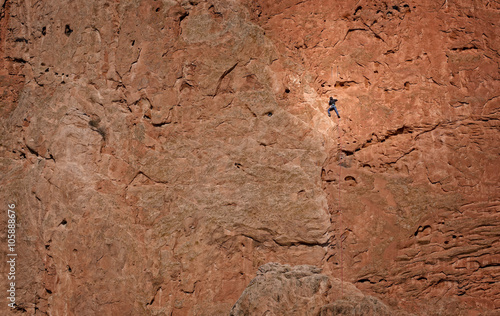 Rock Climber on a massive rock wall in Garden of the Gods, Colorado Springs, Colorado, USA.