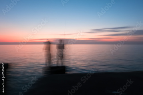 Abstract Blur silhouette of man fishing rod sunset background © teen00000
