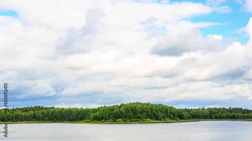 Beautiful lake landscape in forest with reflection of blue sky and running clouds on water surface. Nature, fresh air, purity, nice summer day. Time-lapse 4K. Medium angle. Beautiful lake landscape in forest with reflection of blue sky and running clouds on water surface. Nature, fresh air, purity, nice summer day. Time-lapse 4K. Medium angle.