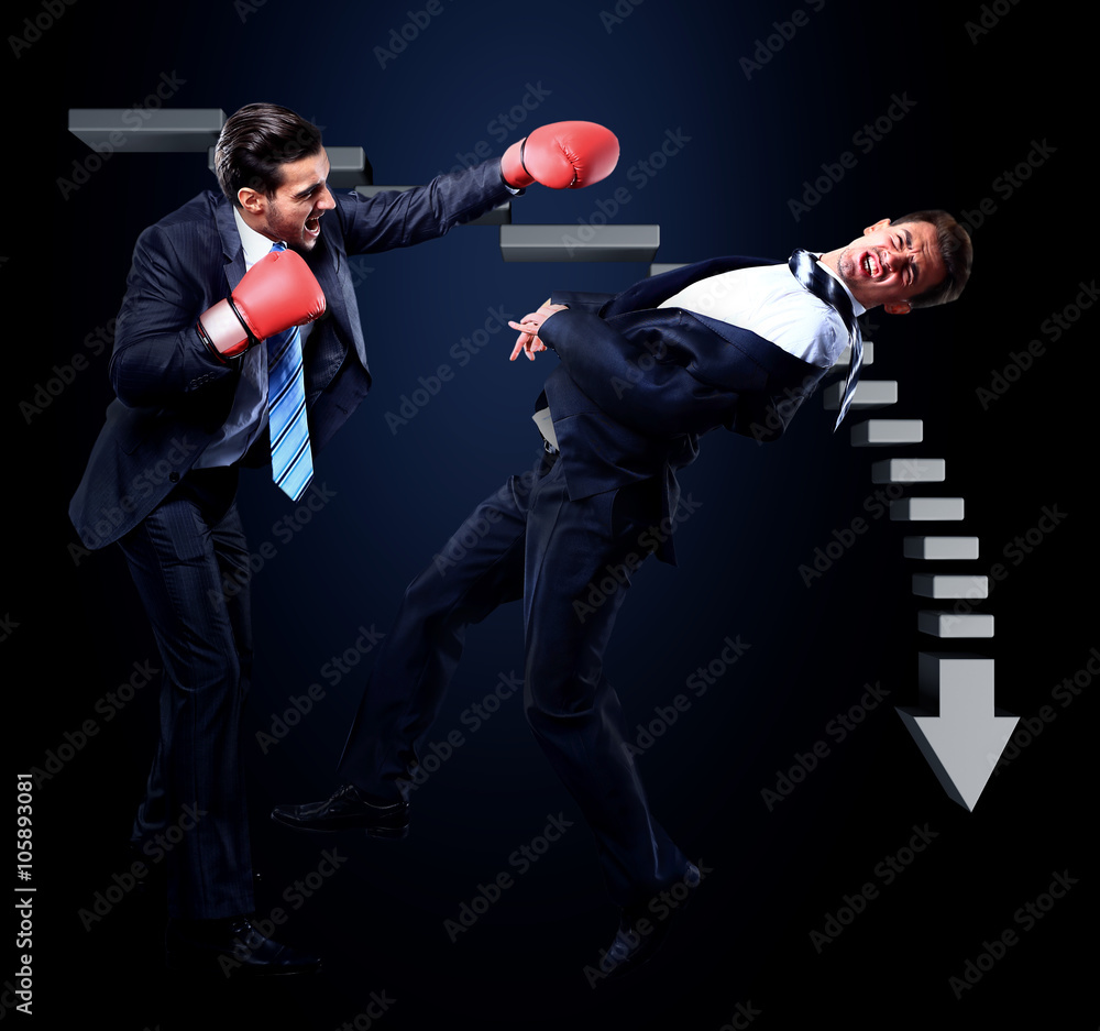 Two young businessman boxing againts dark background Two young businessman boxing againts dark background
