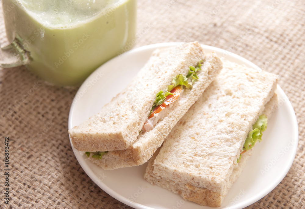  Breakfast with sandwich and ice green tea on gunny sack background