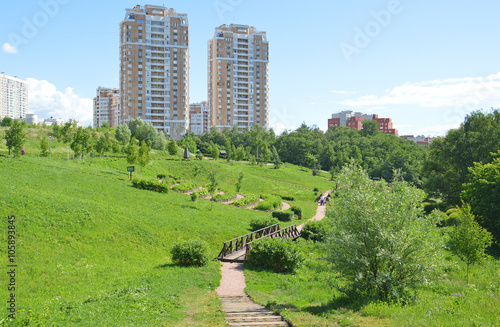 Городской парк на фоне жилых домов летом  photo