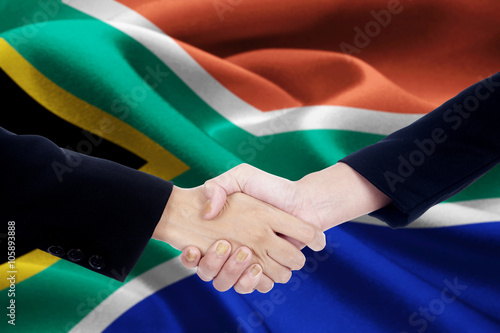 Collaboration handshake with flag of South Africa