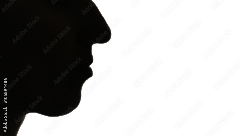 Silhouette shot of a woman blowing into a whistle. Silhouette shot of a woman blowing into a whistle.