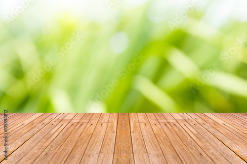 Old wooden table with blur nature background