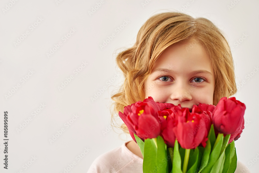 Cute little girl holding the bunch of flowers Cute little girl holding the bunch of flowers