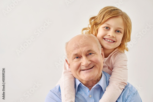 фотографія Little granddaughter hugging her grandfather