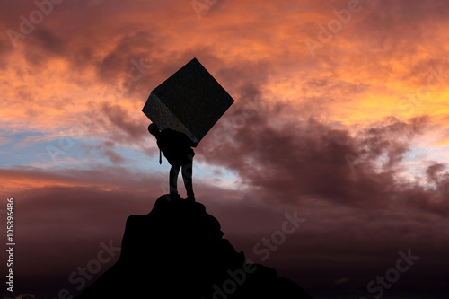 Fotografi Businessman carrying heavy stone package