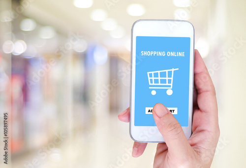 Hand holding smart phone with shopping on line on screen