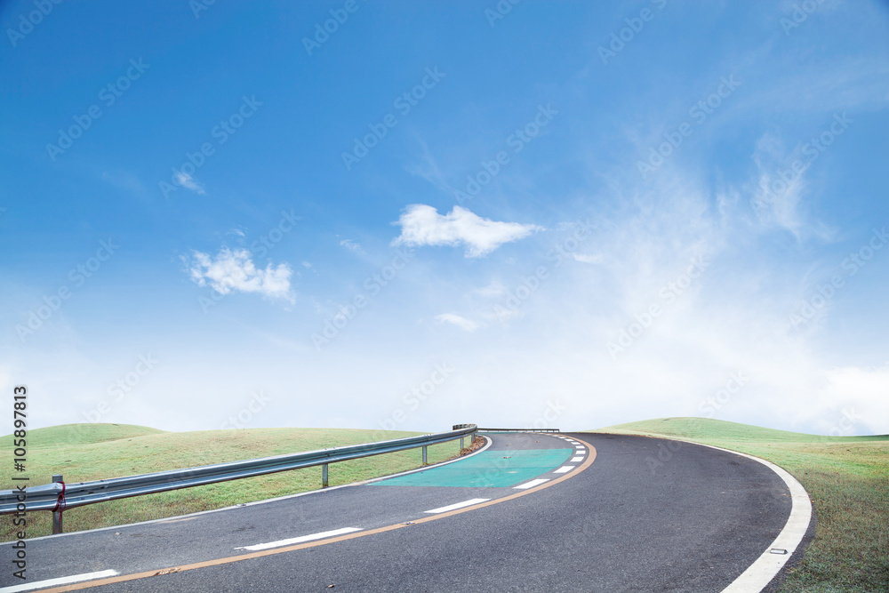 Fototapeta premium Roads and green grass Sky background.