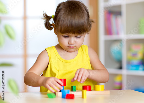 Child girl kid playing with sorter toys