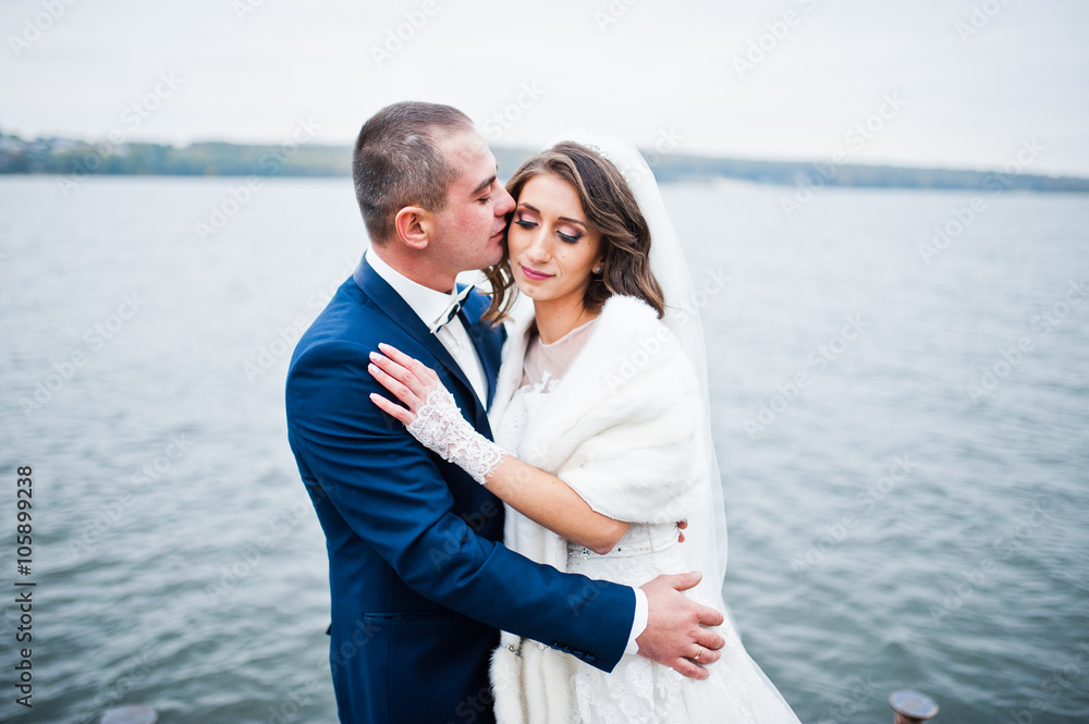 Close up wedding portrait of couple in cloudy weather on the bac