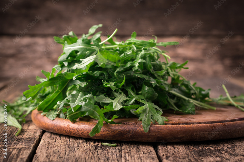 fresh arugula ,wooden background, healthy food fresh arugula ,wooden background, healthy food